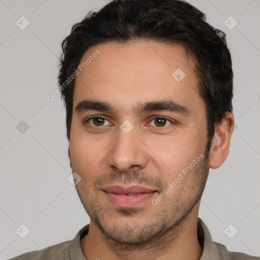 Joyful white young-adult male with short  black hair and brown eyes