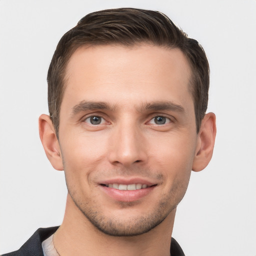 Joyful white young-adult male with short  brown hair and grey eyes