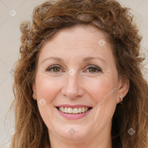 Joyful white adult female with long  brown hair and brown eyes