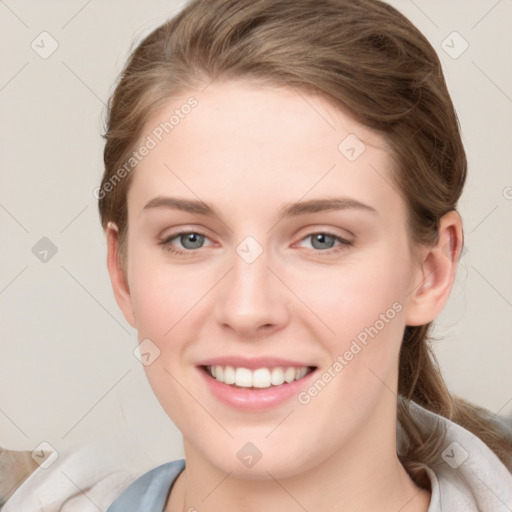 Joyful white young-adult female with medium  brown hair and blue eyes