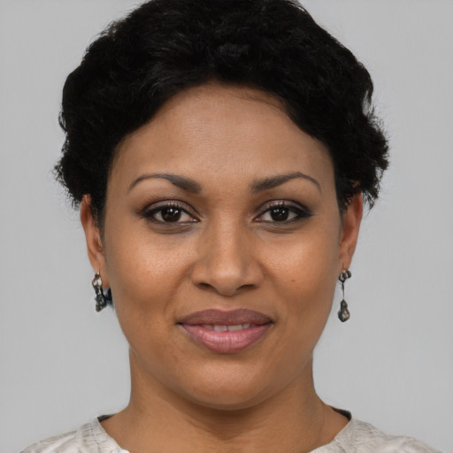 Joyful latino young-adult female with short  black hair and brown eyes