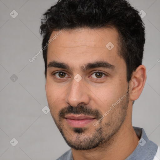 Joyful white young-adult male with short  black hair and brown eyes