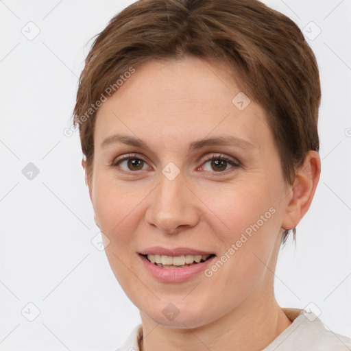 Joyful white young-adult female with short  brown hair and grey eyes