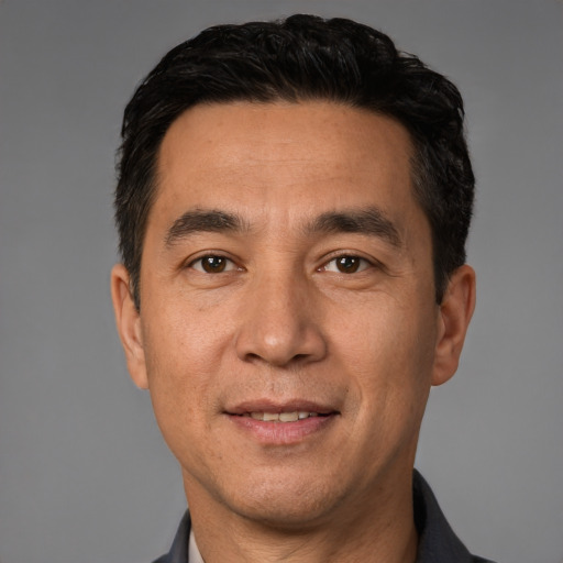 Joyful white adult male with short  black hair and brown eyes