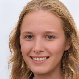 Joyful white young-adult female with long  brown hair and blue eyes