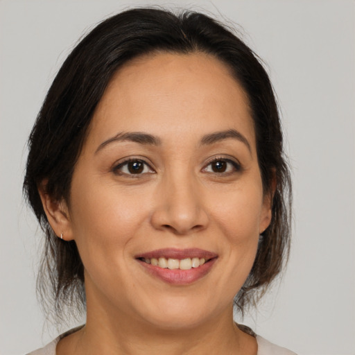 Joyful white young-adult female with medium  brown hair and brown eyes