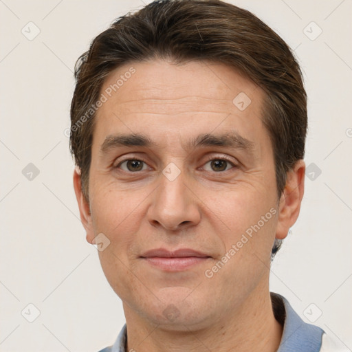 Joyful white adult male with short  brown hair and brown eyes