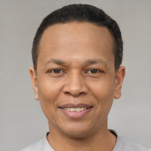 Joyful latino adult male with short  black hair and brown eyes