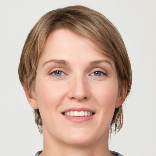 Joyful white young-adult female with medium  brown hair and green eyes