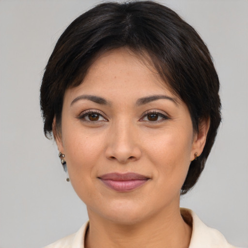 Joyful latino adult female with medium  brown hair and brown eyes