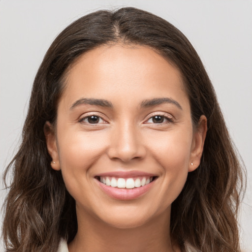 Joyful white young-adult female with long  brown hair and brown eyes