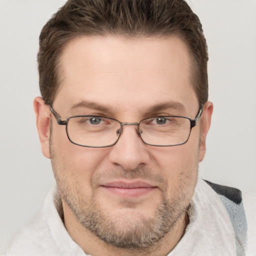 Joyful white adult male with short  brown hair and grey eyes