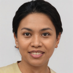 Joyful asian young-adult female with short  brown hair and brown eyes