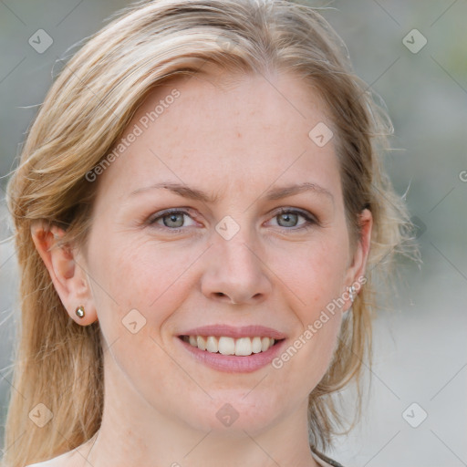 Joyful white young-adult female with medium  brown hair and blue eyes