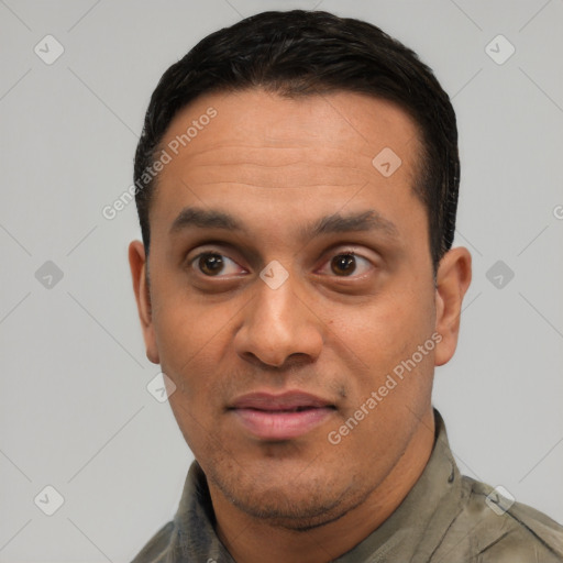 Joyful white adult male with short  black hair and brown eyes