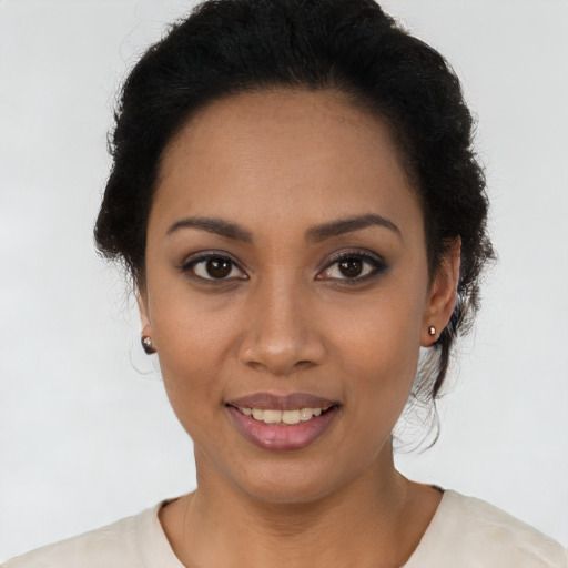 Joyful latino young-adult female with short  black hair and brown eyes