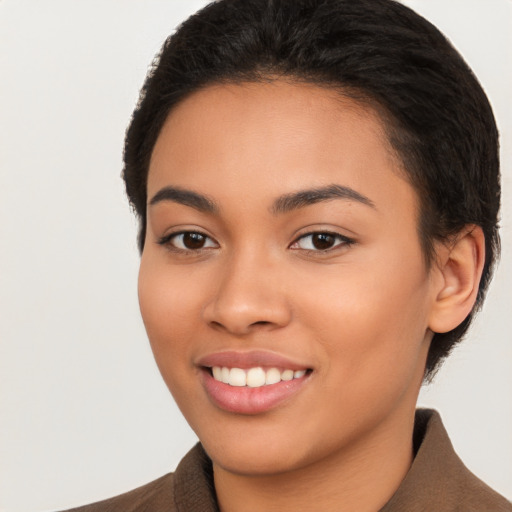 Joyful latino young-adult female with short  black hair and brown eyes