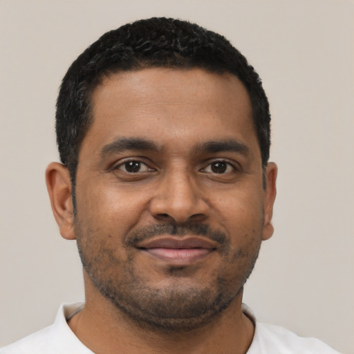 Joyful black young-adult male with short  black hair and brown eyes