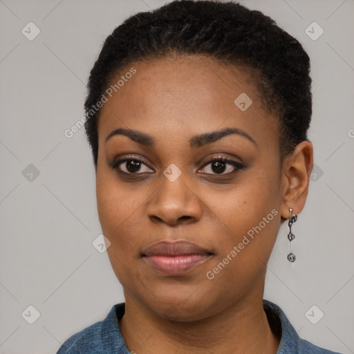 Joyful black young-adult female with short  black hair and brown eyes