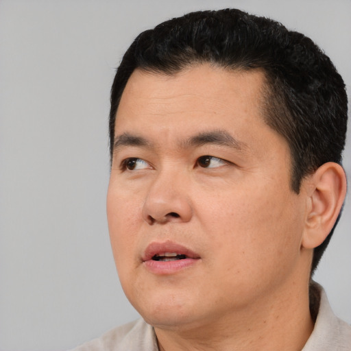 Neutral asian young-adult male with short  black hair and brown eyes