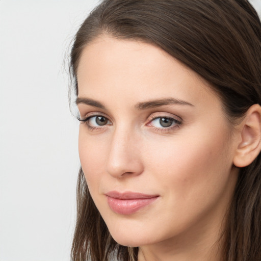 Neutral white young-adult female with long  brown hair and brown eyes