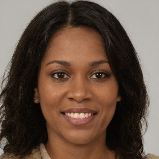 Joyful black young-adult female with medium  brown hair and brown eyes