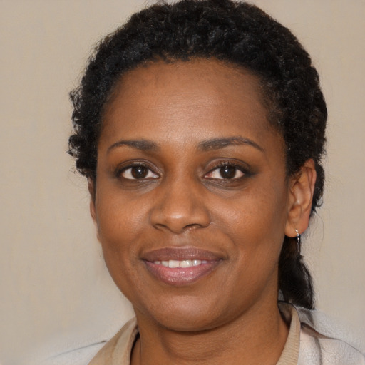 Joyful black young-adult female with medium  brown hair and brown eyes