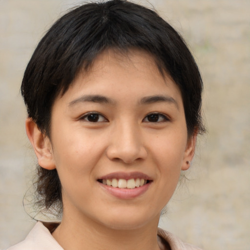 Joyful asian young-adult female with medium  brown hair and brown eyes