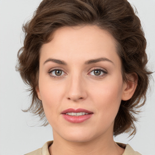 Joyful white young-adult female with medium  brown hair and green eyes