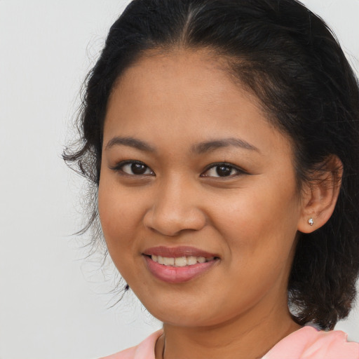 Joyful latino young-adult female with medium  brown hair and brown eyes