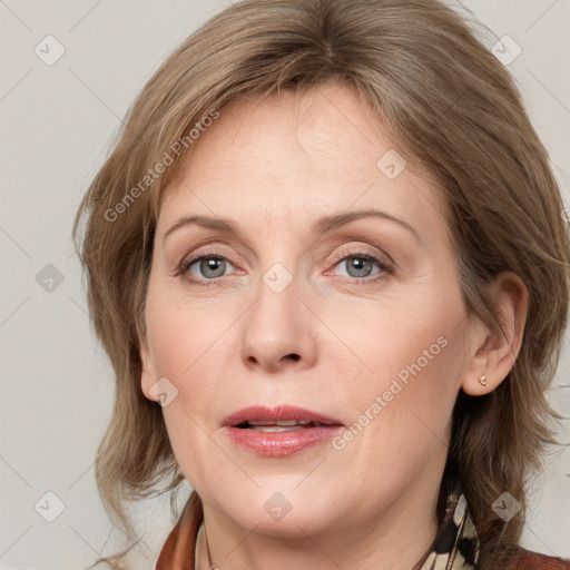 Joyful white adult female with medium  brown hair and grey eyes