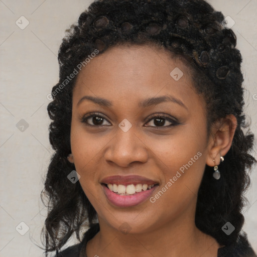 Joyful black young-adult female with long  black hair and brown eyes