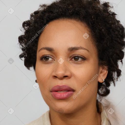 Joyful black adult female with medium  brown hair and brown eyes