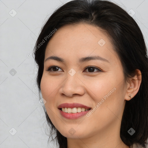 Joyful asian young-adult female with medium  brown hair and brown eyes