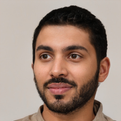 Joyful latino young-adult male with short  black hair and brown eyes