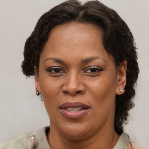 Joyful black adult female with short  brown hair and brown eyes