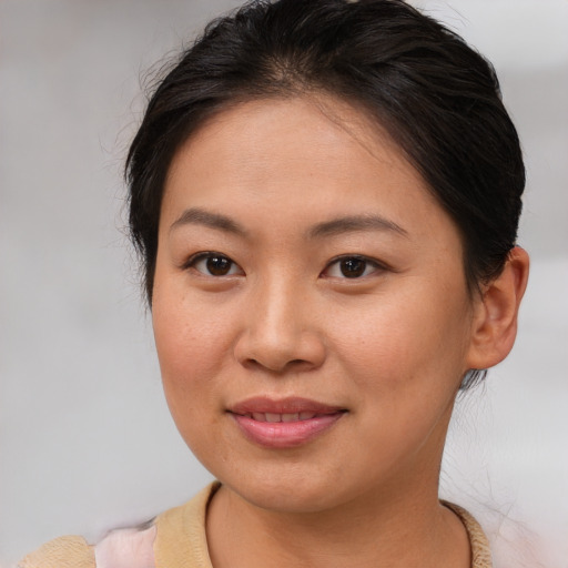 Joyful asian young-adult female with medium  brown hair and brown eyes