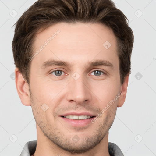 Joyful white young-adult male with short  brown hair and grey eyes