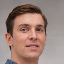 Joyful white adult male with short  brown hair and grey eyes