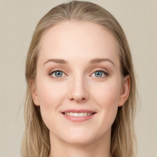 Joyful white young-adult female with long  brown hair and blue eyes