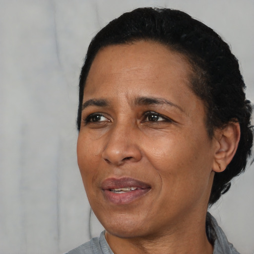 Joyful black adult female with short  black hair and brown eyes