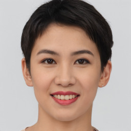 Joyful asian young-adult female with short  brown hair and brown eyes