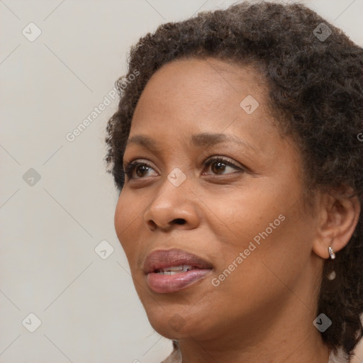 Joyful black adult female with short  brown hair and brown eyes