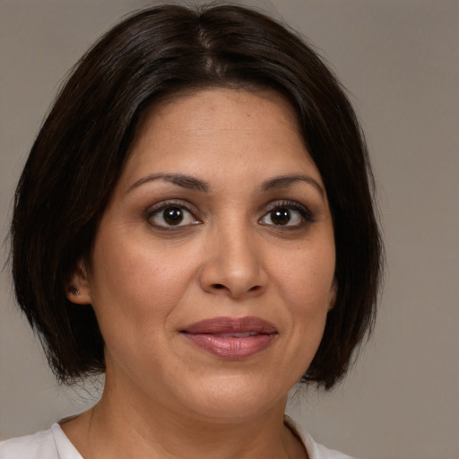 Joyful white adult female with medium  brown hair and brown eyes