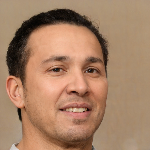 Joyful white adult male with short  brown hair and brown eyes