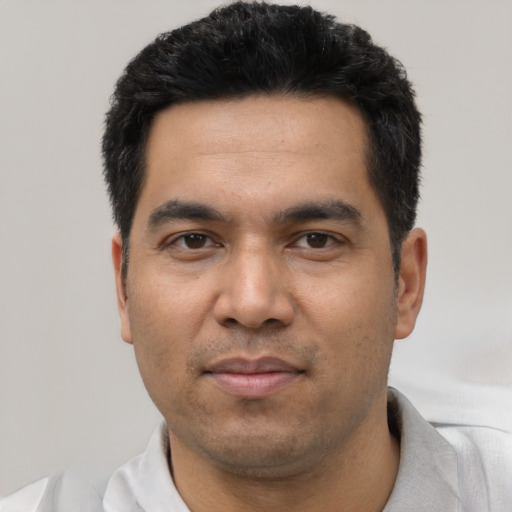 Joyful asian young-adult male with short  black hair and brown eyes