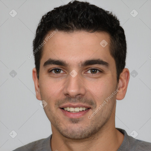 Joyful white young-adult male with short  black hair and brown eyes