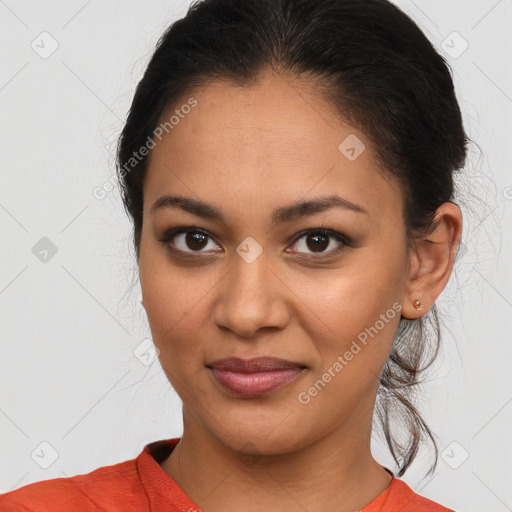 Joyful latino young-adult female with medium  brown hair and brown eyes