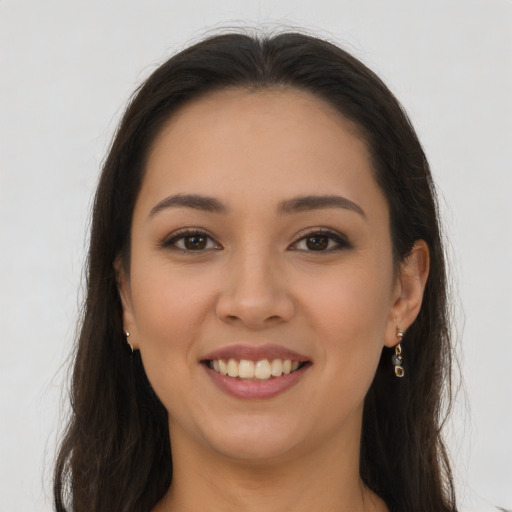 Joyful latino young-adult female with long  brown hair and brown eyes