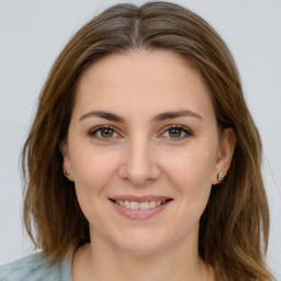 Joyful white young-adult female with medium  brown hair and green eyes